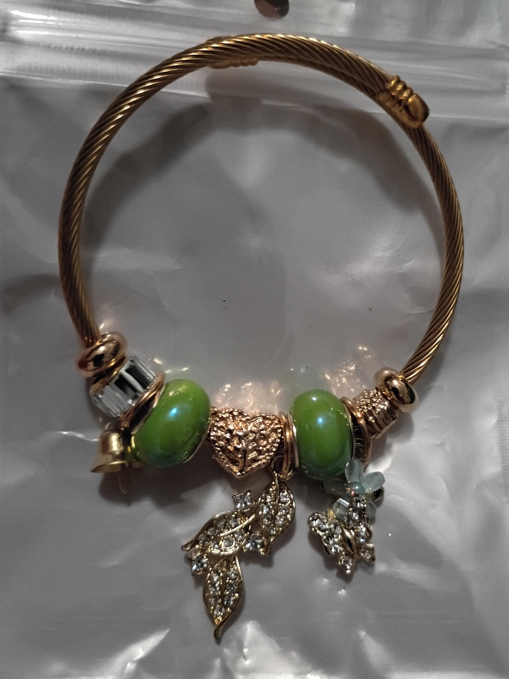 Gold-Tone Bracelet with Green Beads and Leaf Charms